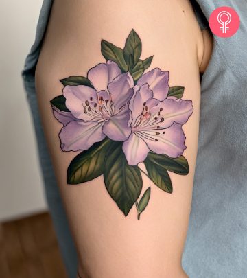 A purple rhododendron tattoo on the upper arm