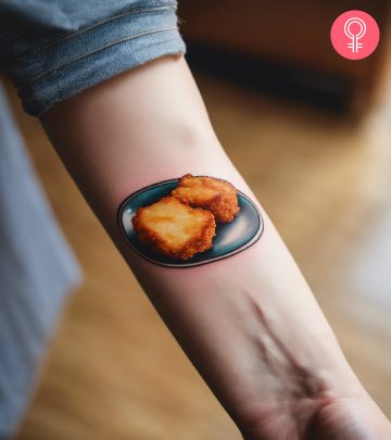 A realistic plate of chicken nugget tattoos on the forearm