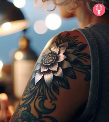 A silver tattoo design on the arm of a woman