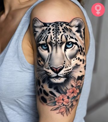 A snow leopard tattoo on the arm of a woman