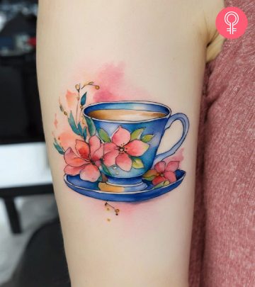 A teacup tattoo on a woman’s upper arm