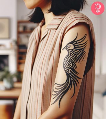 A tribal phoenix tattoo on the arm