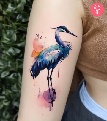 A woman with a Japanese crane tattoo on her arm