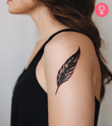 A woman with a black quill tattoo on her upper arm