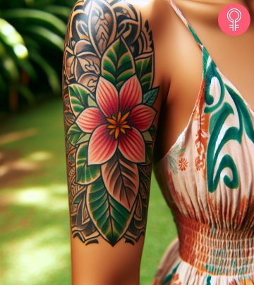 A woman with a floral Fijian tattoo on her upper arm