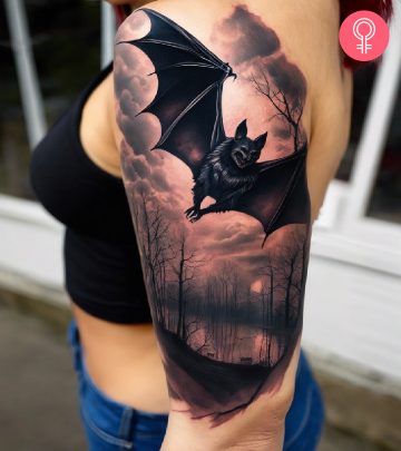 A woman with a horror bat tattoo on her upper arm