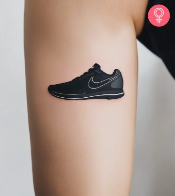 A woman with a nike shoe tattoo on her upper arm