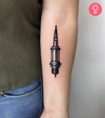 A woman with a spark plug engineering tattoo on her upper arm