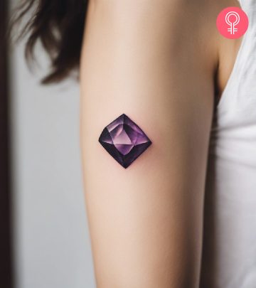 A woman with an amethyst tattoo on her upper arm