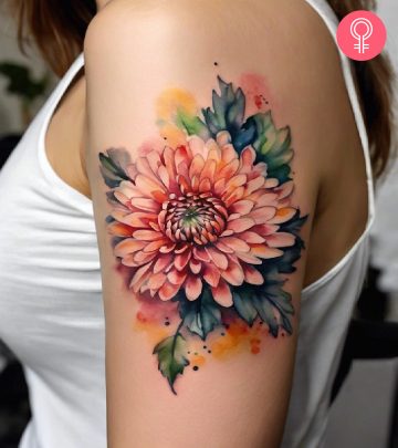 A watercolor chrysanthemum inked on the upper arm.