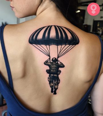 Airborne tattoo on the upper back of a woman
