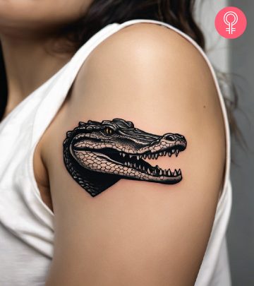 Alligator tattoo on the upper arm