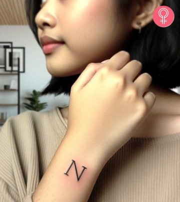 An N letter tattoo on the back of the hand