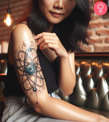 An atom tattoo design on the arm of a woman