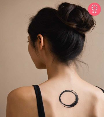 An enso circle tattoo on the back of a woman’s neck