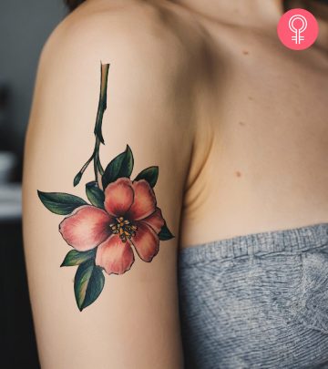 An inverted tattoo on a woman’s upper arm