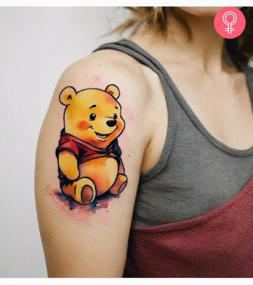 Winnie the Pooh tattoo on the upper arm