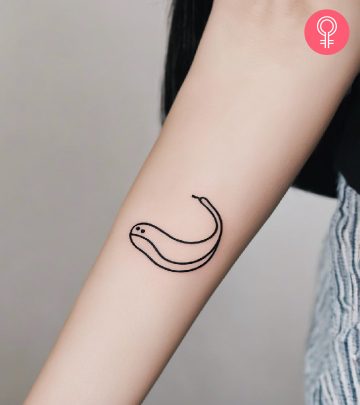 Woman with a minimalist worm tattoo on the forearm
