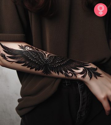 Devil wings tattoo on the forearm of a woman