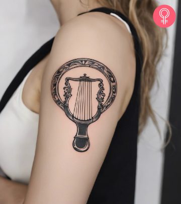 An Apollo lyre tattoo on the upper arm