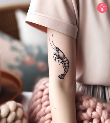 Minimalist shrimp tattoo on the upper arm