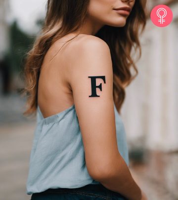 F tattoo on the upper arm