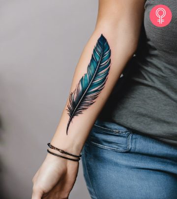 Feather tattoo design on the forearm of a woman