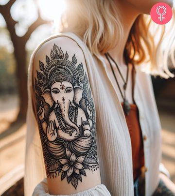 Ganesh tattoo on the upper arm of a woman