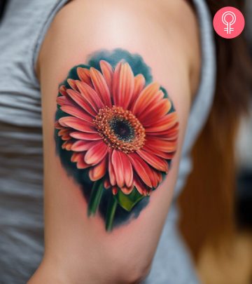 Gerbera daisy tattoo on the arm of a woman