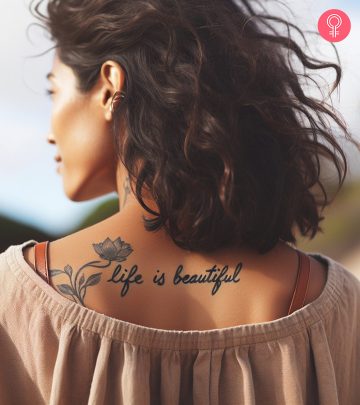 A ‘Life Is Beautiful’ tattoo on a woman’s back