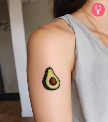 A woman with an avocado tattoo on the upper arm