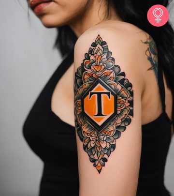 A woman with a T letter tattoo on the upper arm
