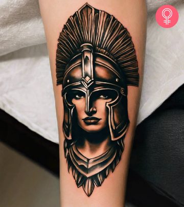 Vintage spartan helmet tattoo on a woman’s forearm