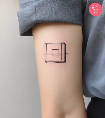 Woman with an unique square tattoo on the upper arm