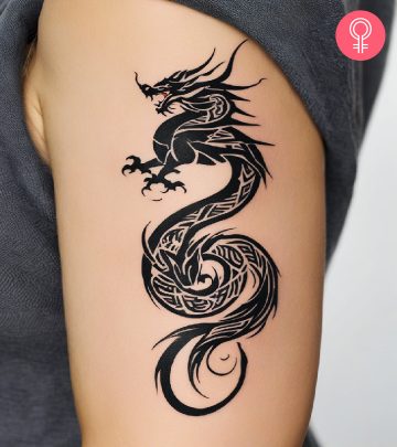 Woman with tribal dragon tattoo on her arm