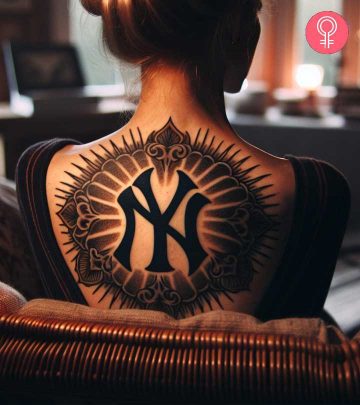 Yankees tattoo on the upper back of a woman