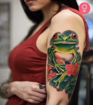 A woman with a vibrant Japanese frog tattoo on her upper arm