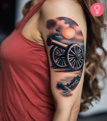 A woman with a colored cannon tattoo on her upper arm