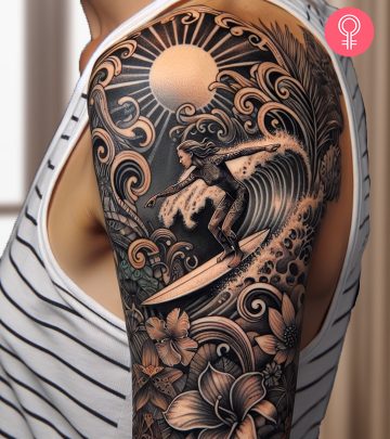 A surfer surfing tattoo on the upper arm