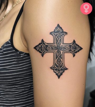 A Filipino cross tattoo on the upper arm