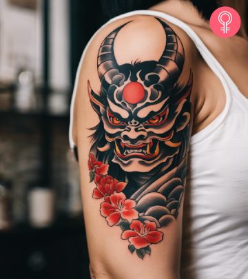 A woman with a Japanese Oni demon tattoo on her upper arm