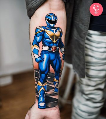 A blue Power Ranger tattoo on the forearm