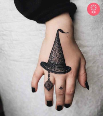 A wizard hat tattoo on a woman’s hand