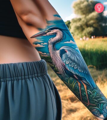 A woman with a blue heron tattoo